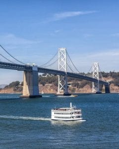 A city cruise boat on the water near the Golden Gate Bridge in San Francisco