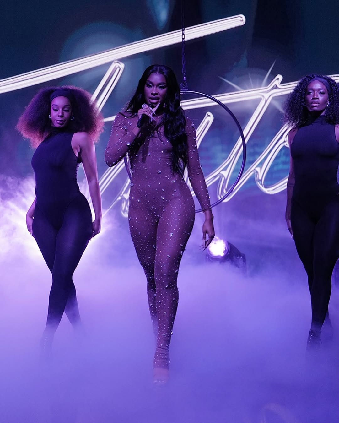 Artist performing on The Tonight Show in front of a crowd.