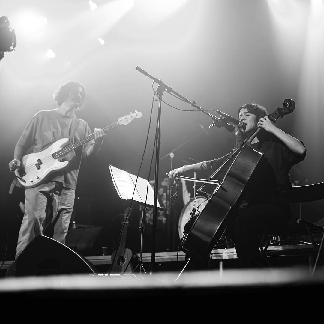 Band performs with bass and guita.