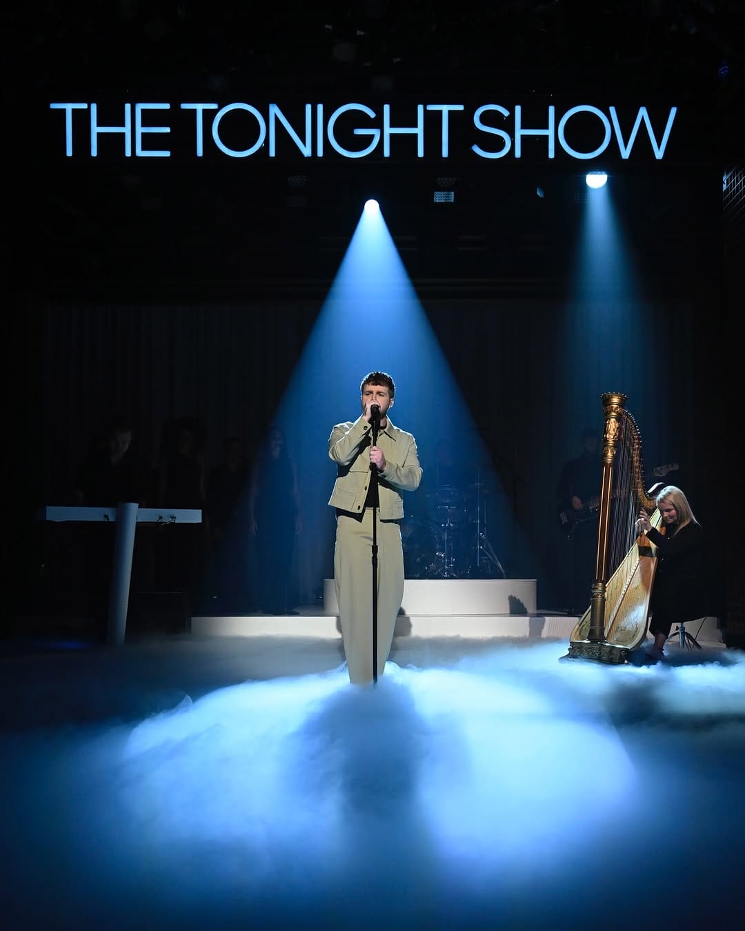 Artist performing on The Tonight Show in front of a crowd. 