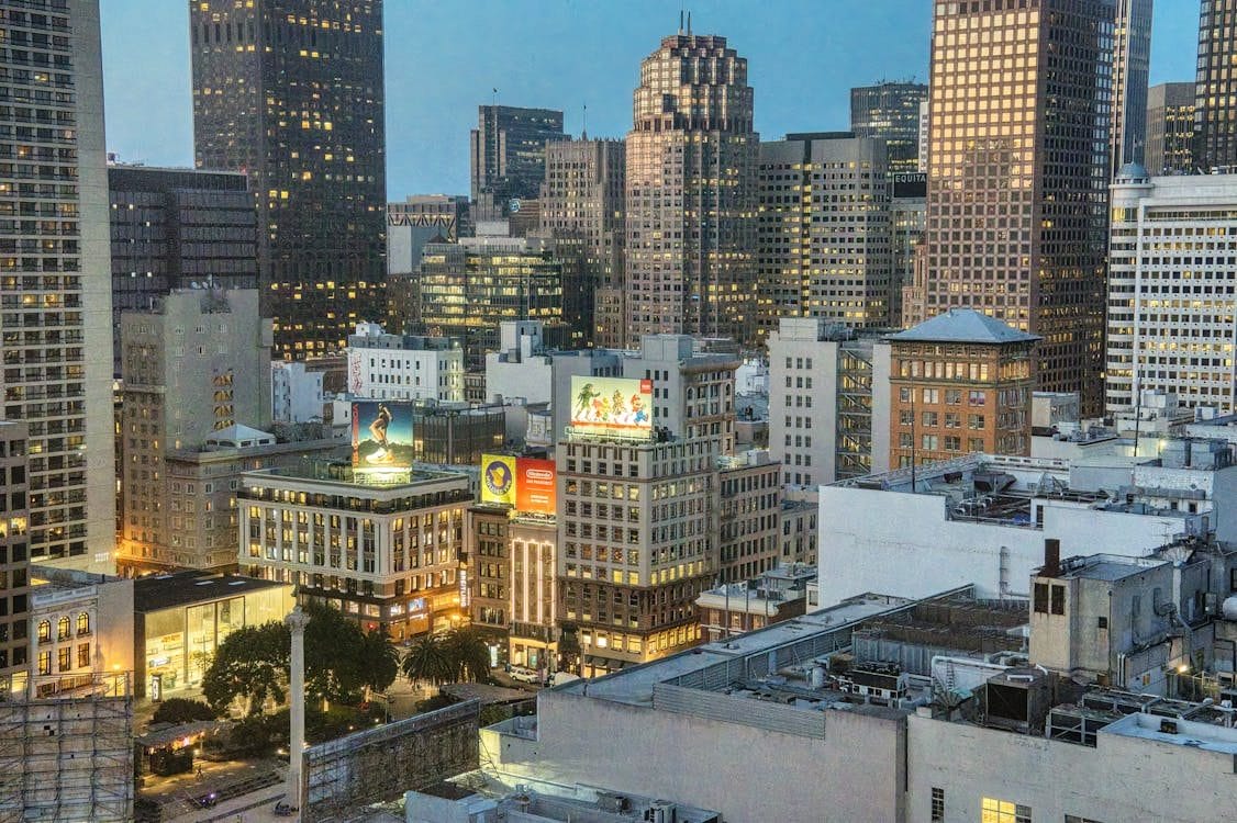 Union Square in downtown San Francisco at twilight with city lights.