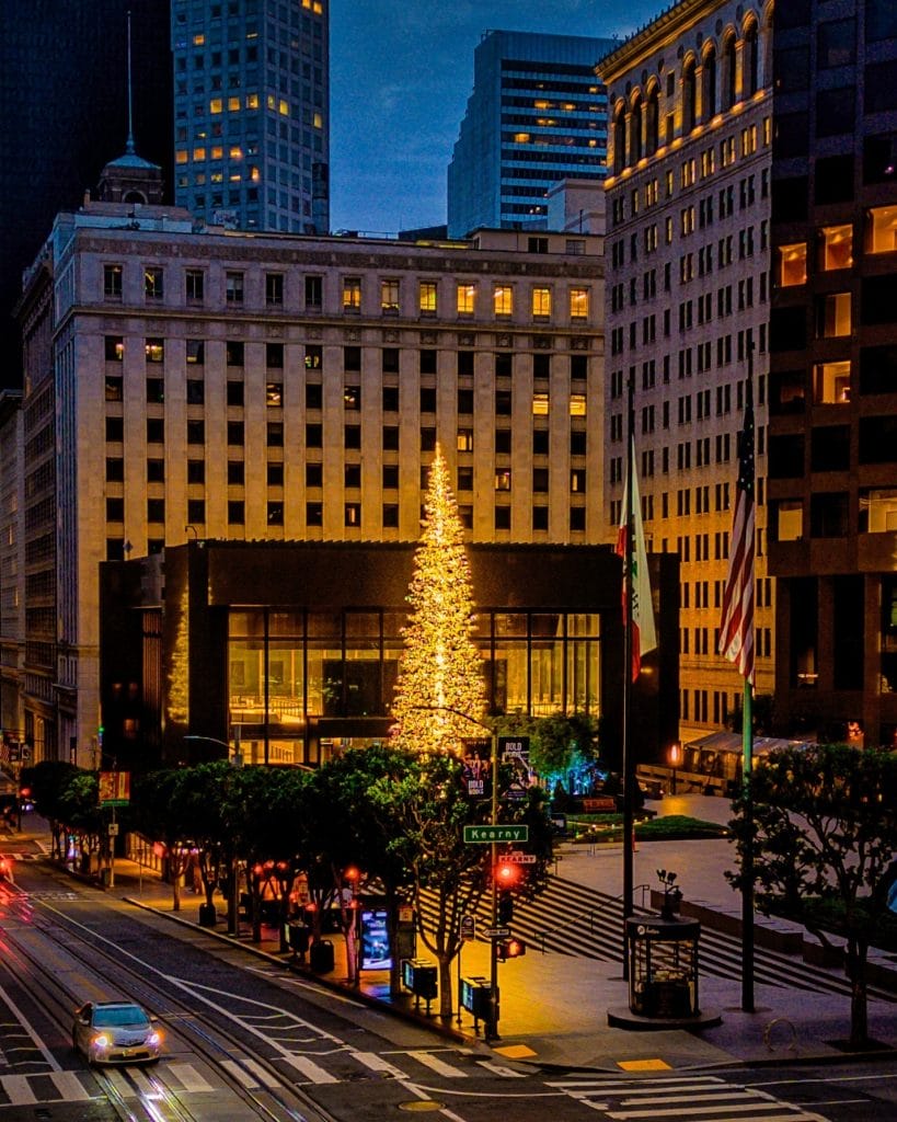 Downtown San Francisco at night with illuminated buildings and holiday lights