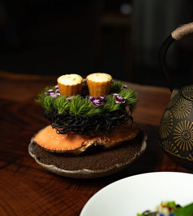 Saison San Francisco, Dungeness Crab warmed over the embers, dressed in roasted shell oil, perilla, and spring garlic.