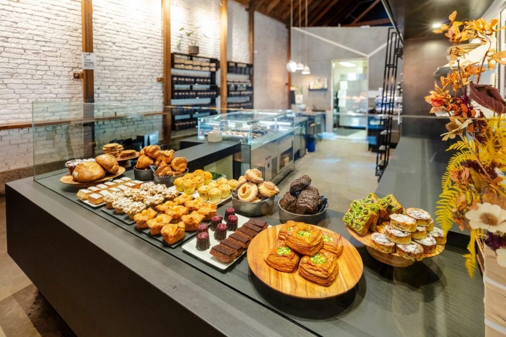 San Francisco Restaurants bakery display with pastries, croissants, cookies, cakes, and desserts arranged on a glass counter.