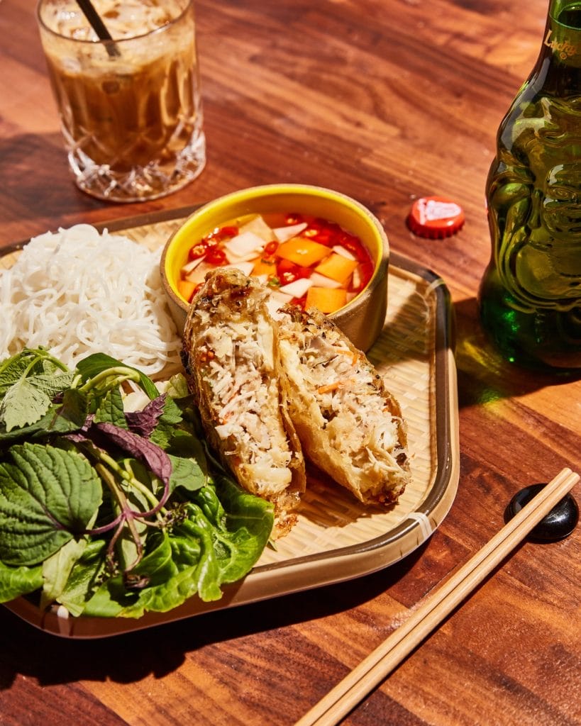 Father’s Day brunch at Bodega SF in San Francisco, featuring Vietnamese noodles, herbs, dipping sauce, and a crispy filled pastry on a tray.