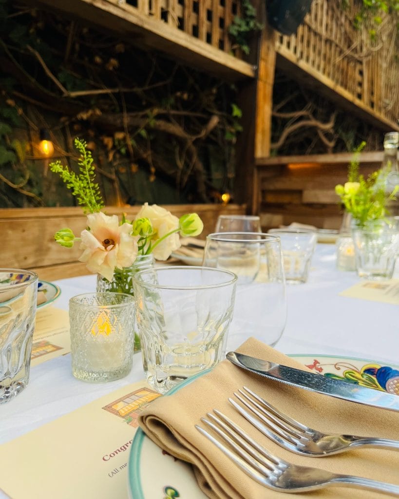 Father’s Day brunch at Zazie in San Francisco, featuring a set outdoor table with flowers, glassware, plates, and silverware.