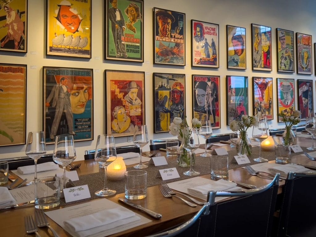 Father’s Day brunch at Foreign Cinema in San Francisco, featuring a set dining table with candles, flowers, wine glasses, and framed artwork on the wall.