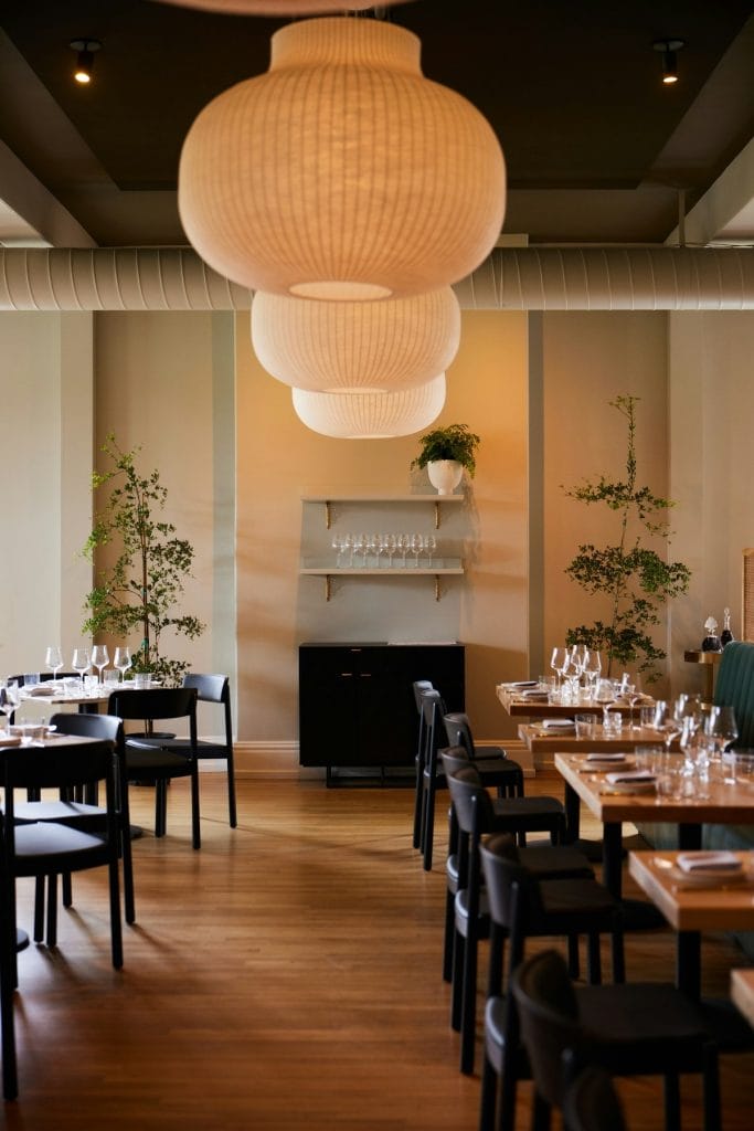 Father’s Day brunch at Dalida in San Francisco, featuring a warm dining room with set tables, hanging lights, and wine glasses.