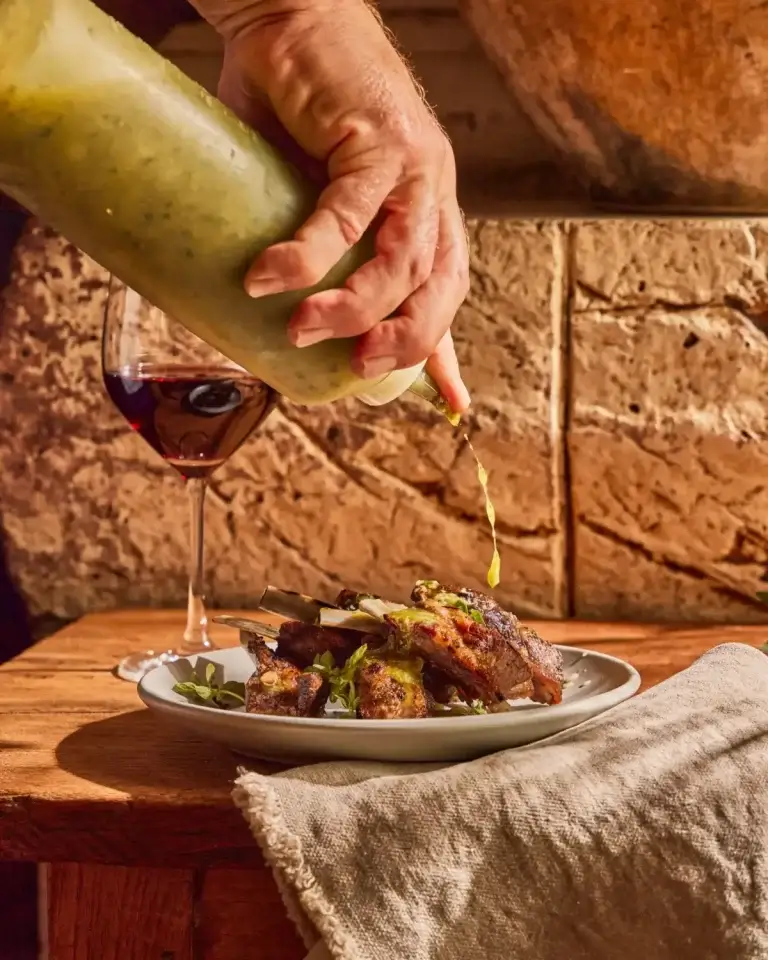Wood-Fired restaurants in San Francisco, pouring sauce on steak