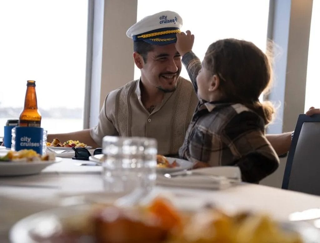 Father and child sharing a meal on a City Cruises boat for Father’s Day Events San Francisco.