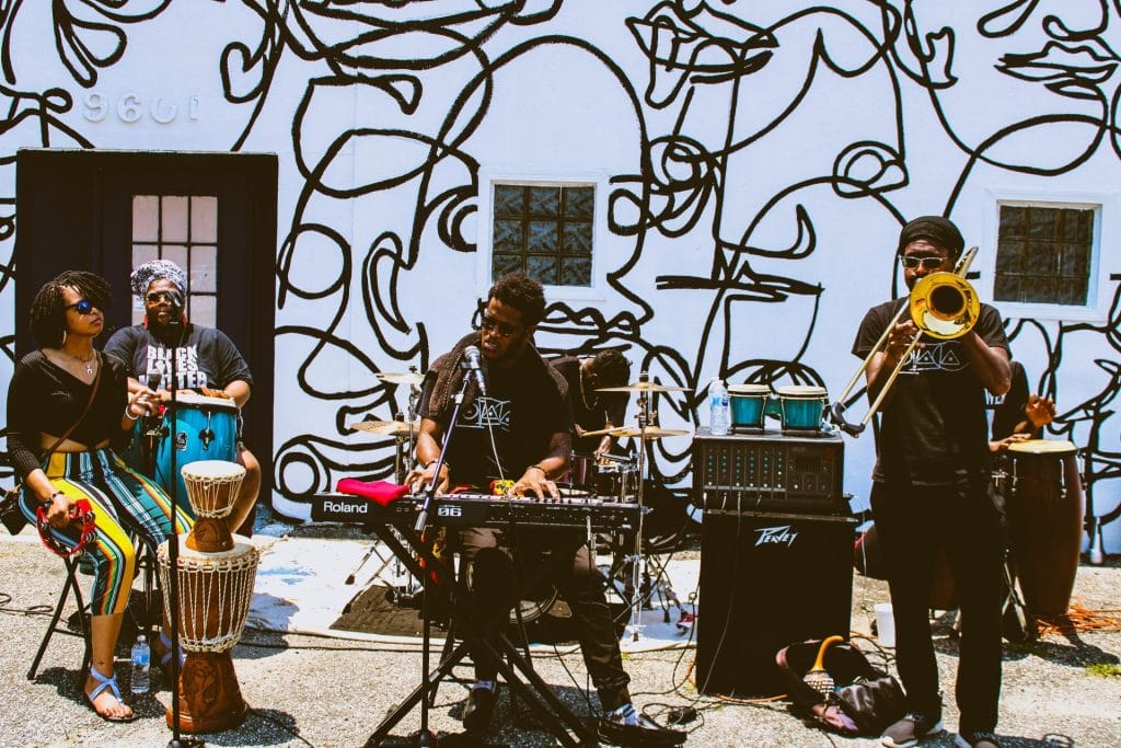 Live band performing outdoors in front of a mural during a San Francisco community event for Father’s Day Events San Francisco.