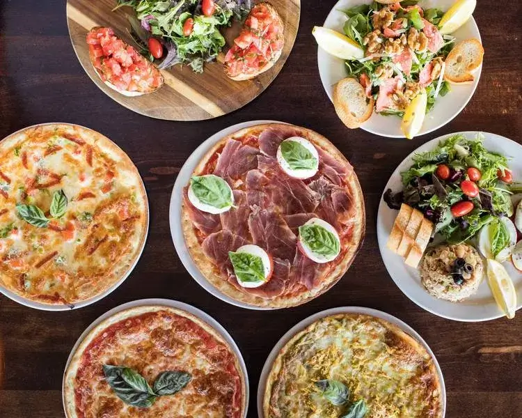 Italian dishes including prosciutto and mozzarella pizza, bruschetta and mixed salads.