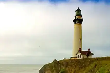 Pigeon Point Lighthouse on a grassy cliff overlooking the Pacific Ocean