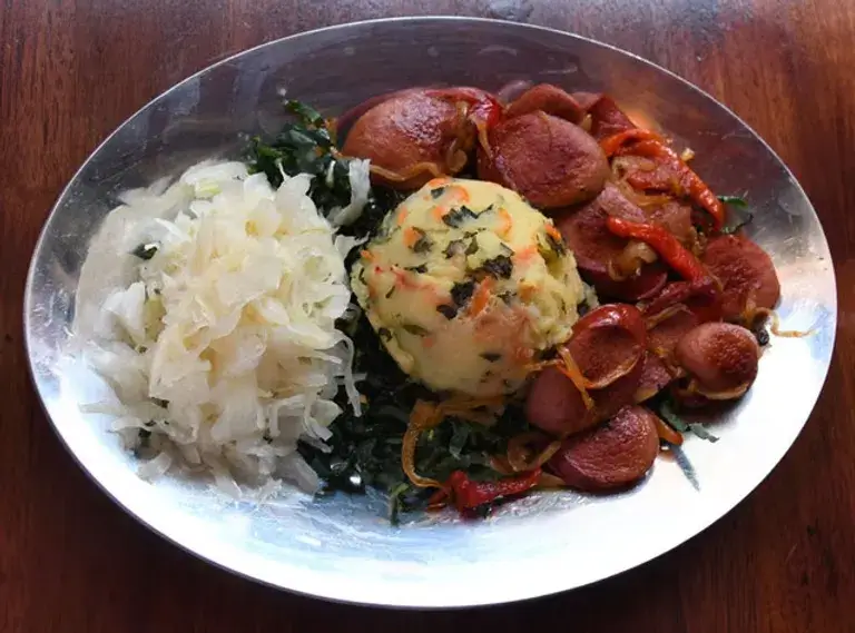 kale mashed potatoes, topped with smoky sausages
