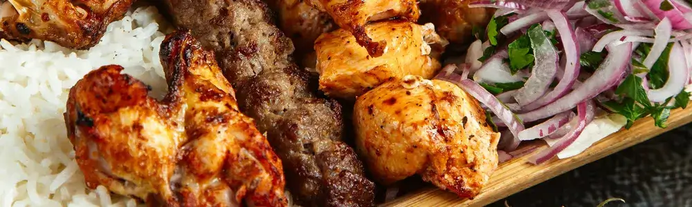 grill platter with chicken, kabobs, grilled steak, beef cubes and meat skewers. Yummy Plate