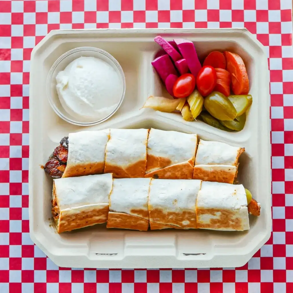 Chicken Arabi. chicken wrap cut into bite-sized pieces and served with sides of toum, house-made pickles, and your choice of side.