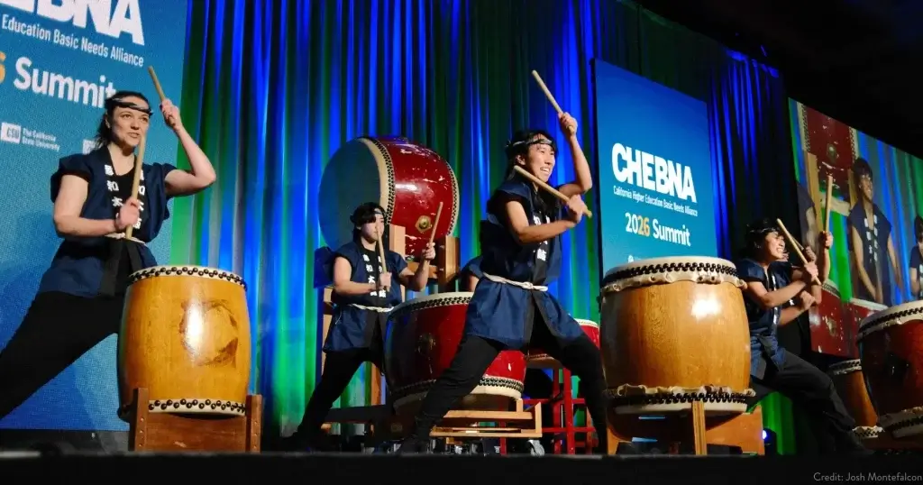 Iwa Daiko performers playing large taiko drums on stage during a live cultural performance in San Francisco.