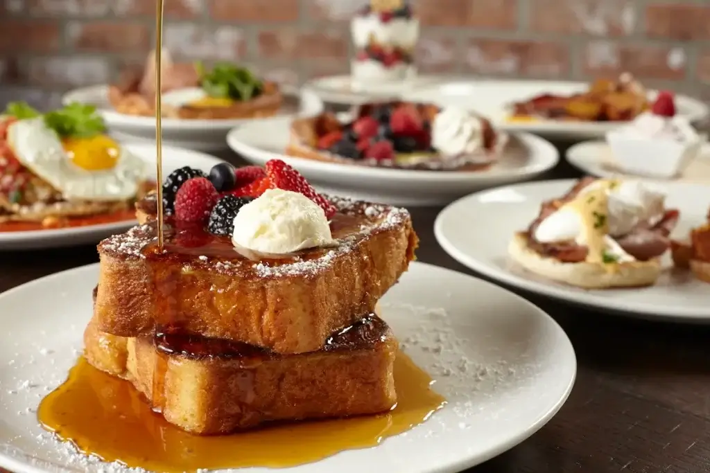 hidden restaurant brunch menu. french toast with berries and powdered sugar and whipped cream