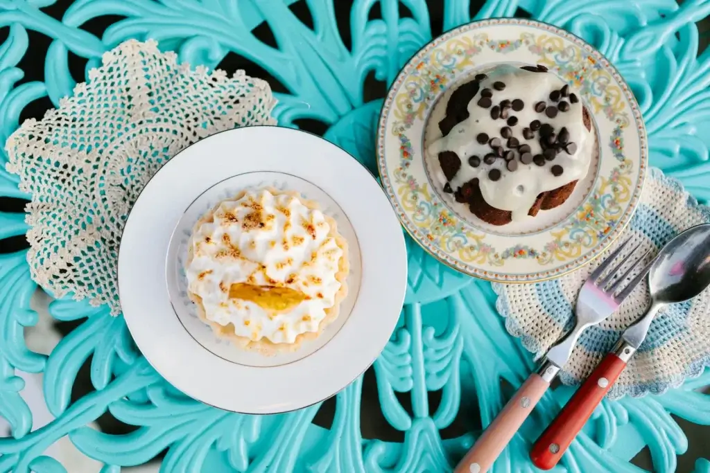 lemon meringue tart and chocolate tart with white cream and chocolate chips.