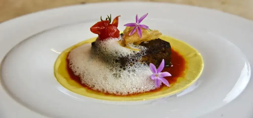 Hidden restaurants outside San Francisco, Quinto Quarto with heirloom tomato, egg yolk pasta, crispy garlic and edible purple flowers topped with culinary foam