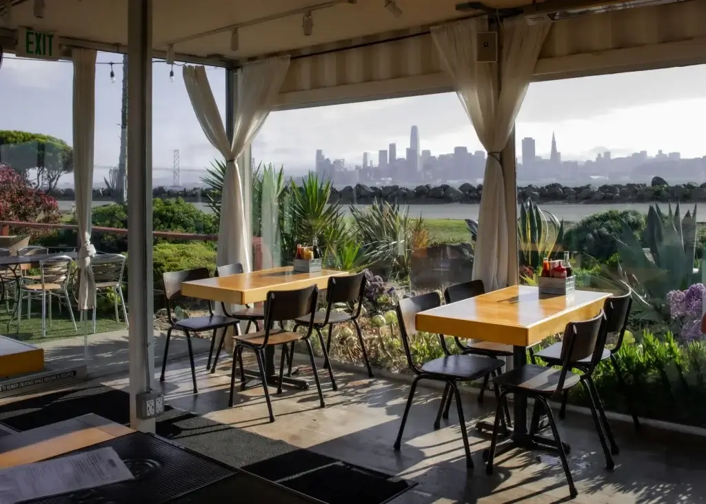 Mersea restaurant on Treasure Island in San Francisco, outdoor seating with waterfront and sunset views